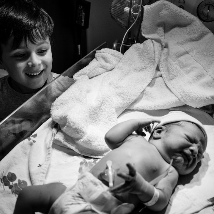 Toddler meets baby brother for the first time