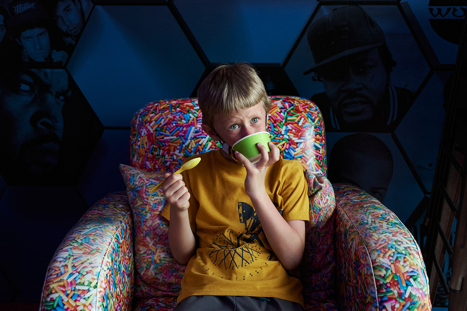 kid eating ice cream in a sprinkle pattern couch